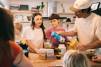 Family preparing smoothies using Gutful together in a kitchen.